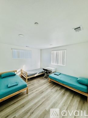 Los Angeles townhouse for rent - A room with two beds and a table.