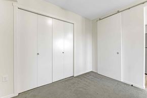 Edmonton apartment for rent - A room with white cupboards and grey carpet.