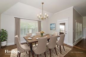 Edmond house for rent - A dining room with a table set for four and a chandelier hanging from the ceiling.