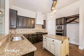 Edmond house for rent - A kitchen with granite countertops and a sink.