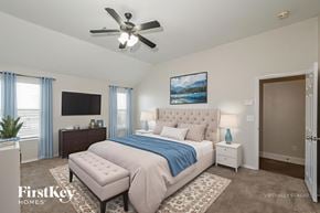 Edmond house for rent - A bedroom with a large bed, a ceiling fan, and a painting on the wall.