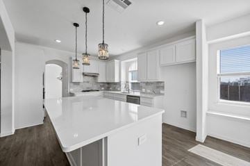Forney house for rent - A modern kitchen with white cabinets and a large island.