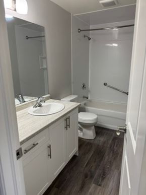 London house for rent - A white bathroom with a sink, toilet and shower.