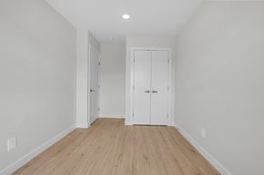 Saskatoon apartment for rent - A room with two white doors and a wooden floor.