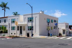 San Diego apartment for rent - A white building with a blue sky in the background.