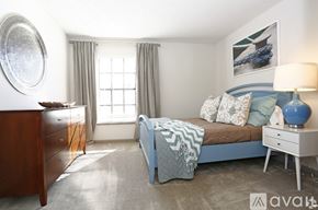 Tampa apartment for rent - A bedroom with a bed, nightstand, and a dresser.