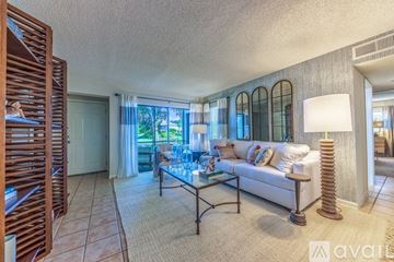 Tampa apartment for rent - A living room with a glass table and a white couch.