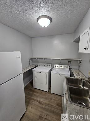 Saint Charles apartment for rent - A washer and dryer are sitting in a laundry room.