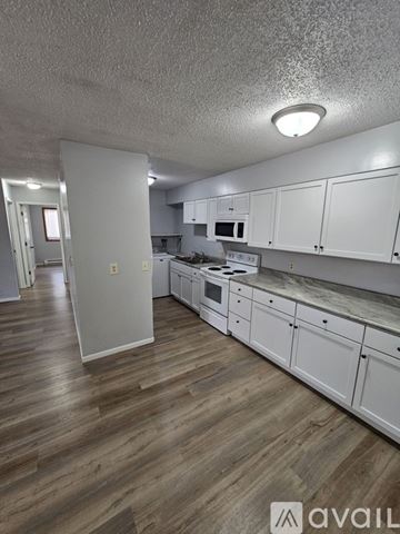 Saint Charles apartment for rent - A kitchen area with a stove top oven and a refrigerator.