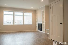 North Mankato townhouse for rent - A spacious room with a fireplace and a door on the right side.