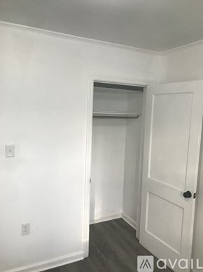 Kinston house for rent - A white door is on the right side of a room with a window above it.