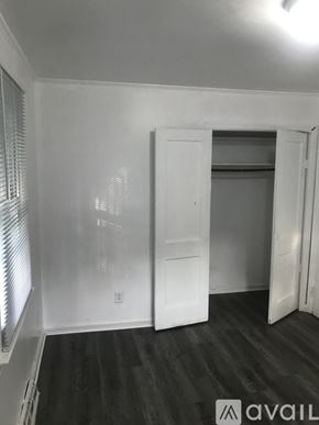 Kinston house for rent - A room with a white door and a window with blinds.