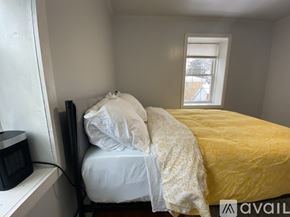 Evanston apartment for rent - A bedroom with a bed, rug, and fan.