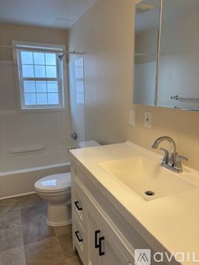 Manchester apartment for rent - A bathroom with a sink, mirror, and cabinets.