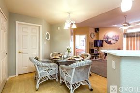 Phoenix condo for rent - A dining room with a table set for two and chairs with a white pattern.