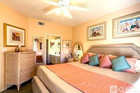 Phoenix condo for rent - A bedroom with a bed, dresser, and ceiling fan.
