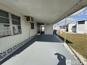 Venice house for rent - A long, narrow, covered walkway with a metal grate on the floor.