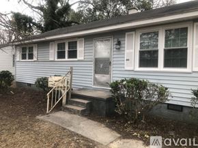 Kinston house for rent - A house with a blue siding and a white door.