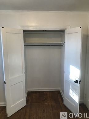 Kinston house for rent - A white door with a shelf above it and a black handle.