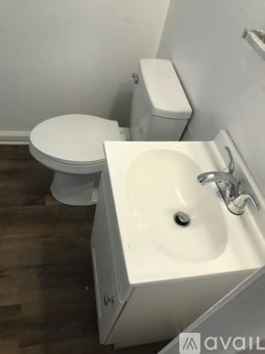 Kinston house for rent - A white toilet and sink in a small bathroom.