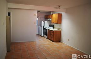 Santa Fe apartment for rent - A kitchen area with tile flooring and wooden cabinets.