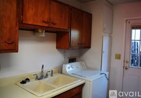Santa Fe apartment for rent - A kitchen with a white washing machine and a white sink.