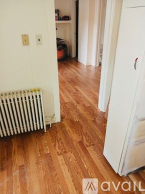 Lake George apartment for rent - A white refrigerator is in a room with wooden floors.