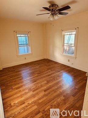 Lake George apartment for rent - A room with wooden flooring and two windows.