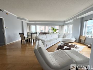 Alexandria condo for rent - A living room with white furniture and a cowhide rug.