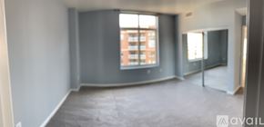 Alexandria condo for rent - A large empty room with a window overlooking a building.