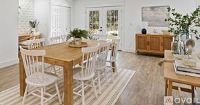 Santa Rosa Beach house for rent - A dining room with a wooden table and chairs.