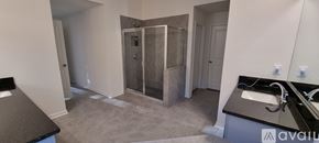 Cumming house for rent - A bathroom with a sink, mirror, and shower.