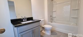 Cumming house for rent - A bathroom with a sink, toilet and bathtub.