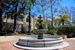 Calabasas apartment for rent - A fountain in the middle of a courtyard with a building in the background.