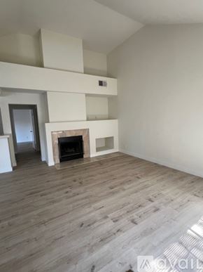 Calabasas apartment for rent - A living room with a fireplace and wooden floors.