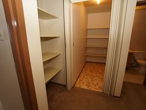 Wainwright apartment for rent - A room with a carpeted floor and a toilet in the background.