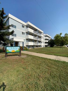 Wainwright apartment for rent - A Sunset Manor apartment complex with a sign in front.