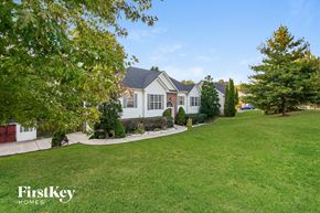 Clarksville house for rent - A large house with a lawn in front of it.