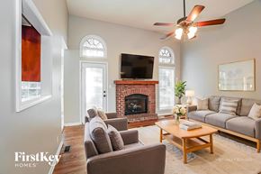 Clarksville house for rent - A living room with a fireplace and a television.