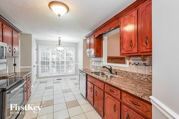 Clarksville house for rent - A kitchen with brown cabinets and a tiled floor.