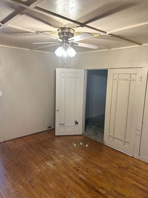 Littlefield house for rent - A room with a ceiling fan and wooden floors.