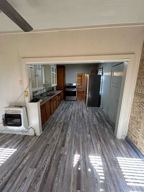 Littlefield house for rent - A kitchen with a refrigerator, microwave, and oven.