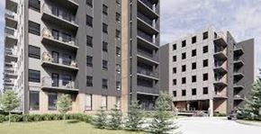 Winnipeg apartment for rent - A large concrete building with balconies and windows.