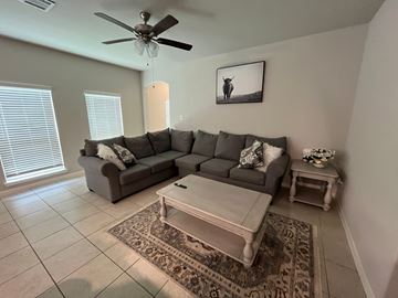 Houston house for rent - A living room with a grey couch and a coffee table.