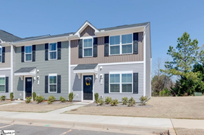 Greenville house for rent - A two-story house with a grey and white exterior and a black front door.