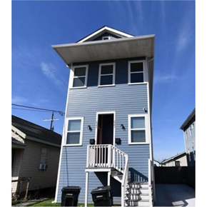 New Orleans apartment for rent - A two-story house with a balcony and a staircase leading to the second floor.