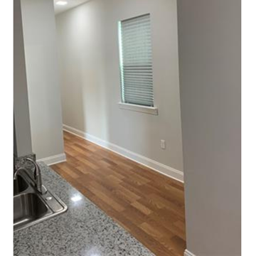 New Orleans apartment for rent - A kitchen with a sink and wooden floors.