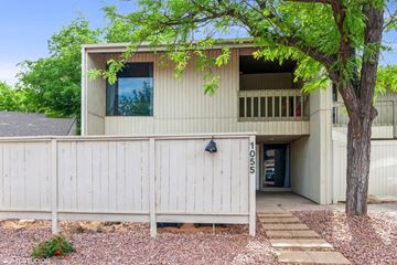 St George house for rent - A modern house with a white fence and a tree in front.