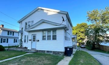 Southbridge apartment for rent - A white house with a blue trash can in front.