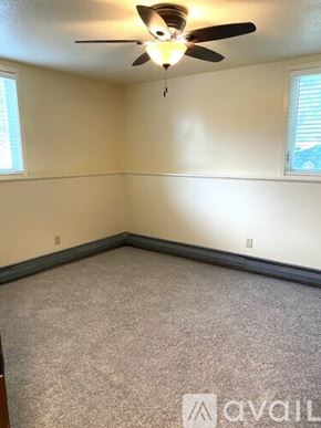 Fairfax apartment for rent - A room with a ceiling fan and carpeted floor.